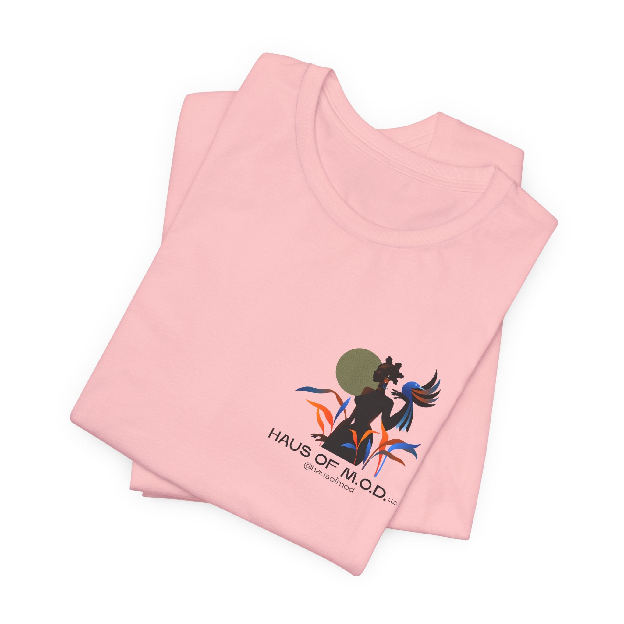 Pink t-shirt with a graphic design and 'Haus of M.O.D.' text on a white background