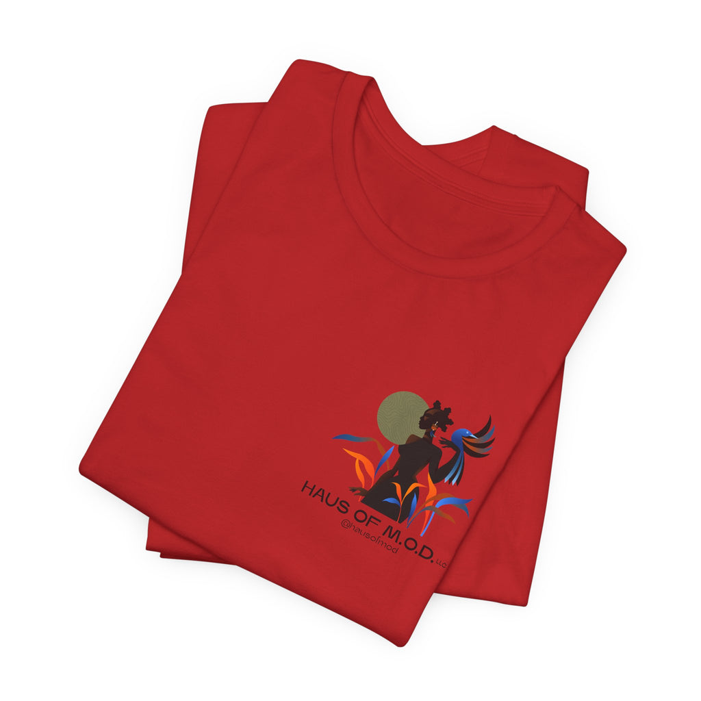 Folded red t-shirt with a graphic design and 'Haus of M.O.D.' text on a white background