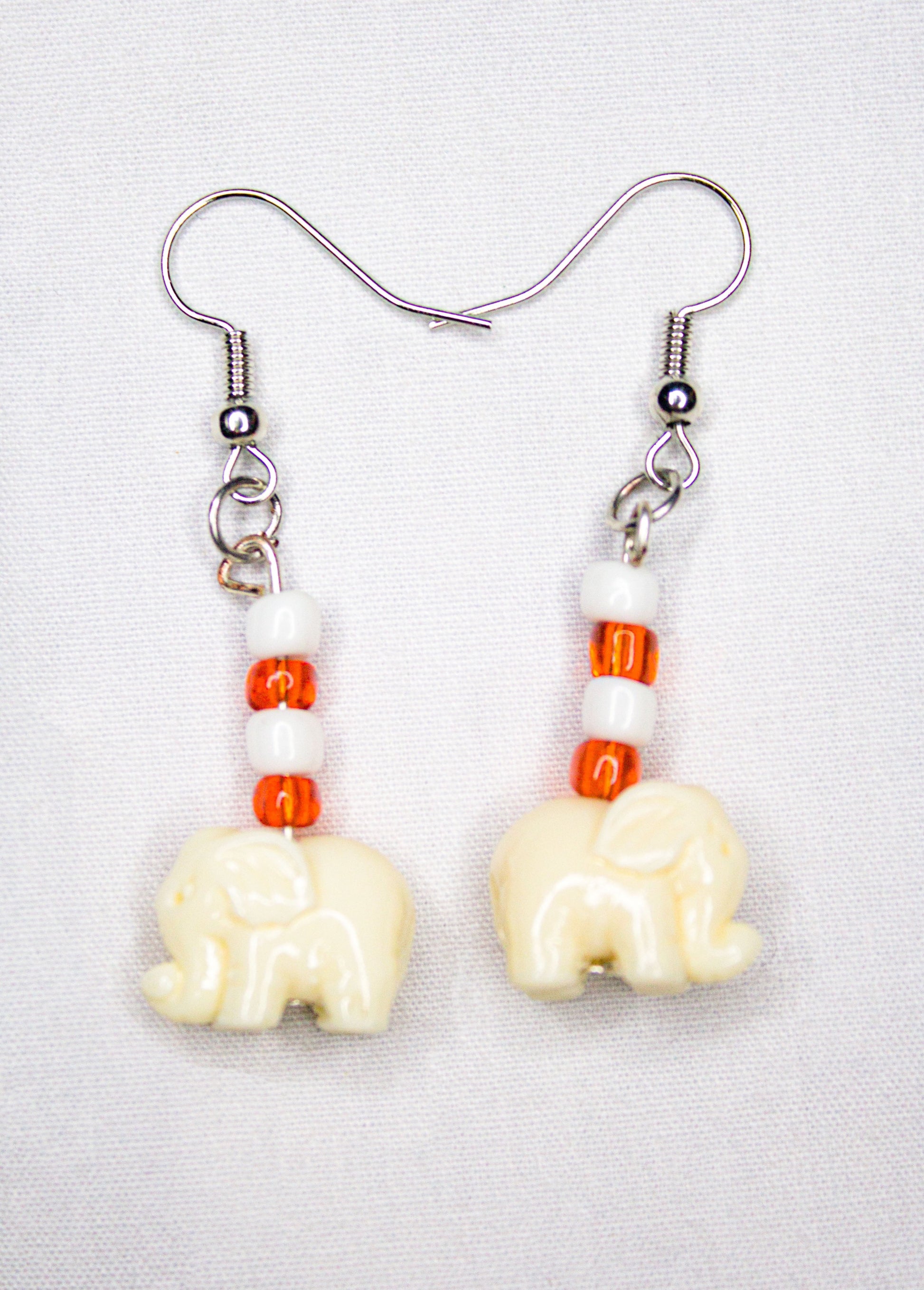 White and orange elephant earrings