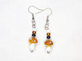 White, brown, and black mushroom earrings
