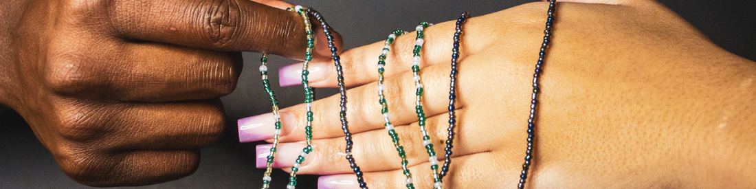 image of two people holding small stringed waistbeads