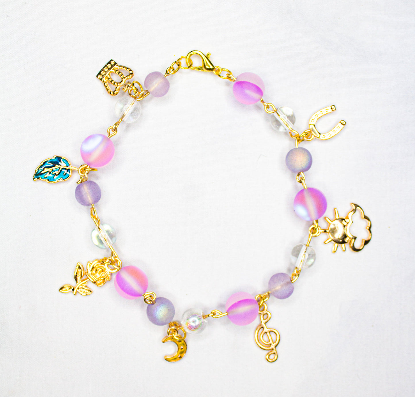 transluncent pink charm bracelet with gold findings