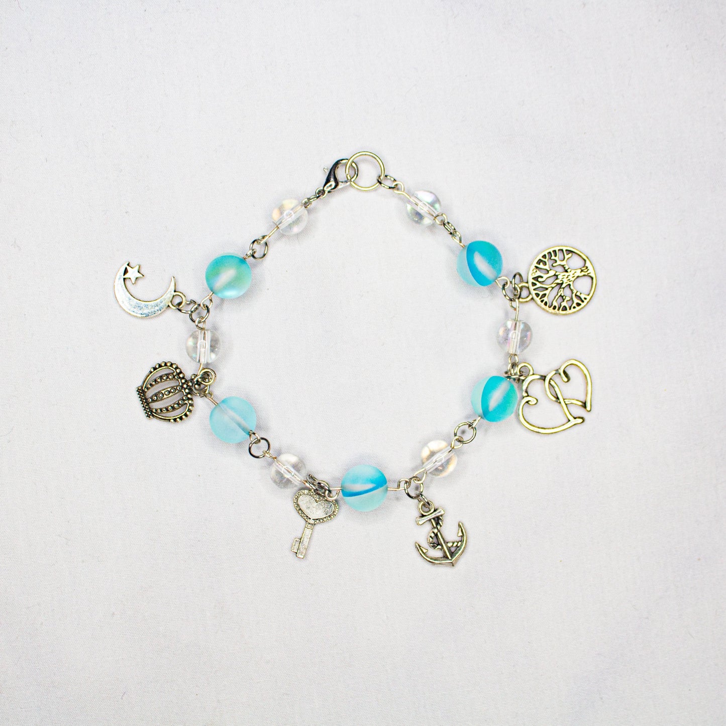 transluncent blue and white charm bracelet with sliver findings